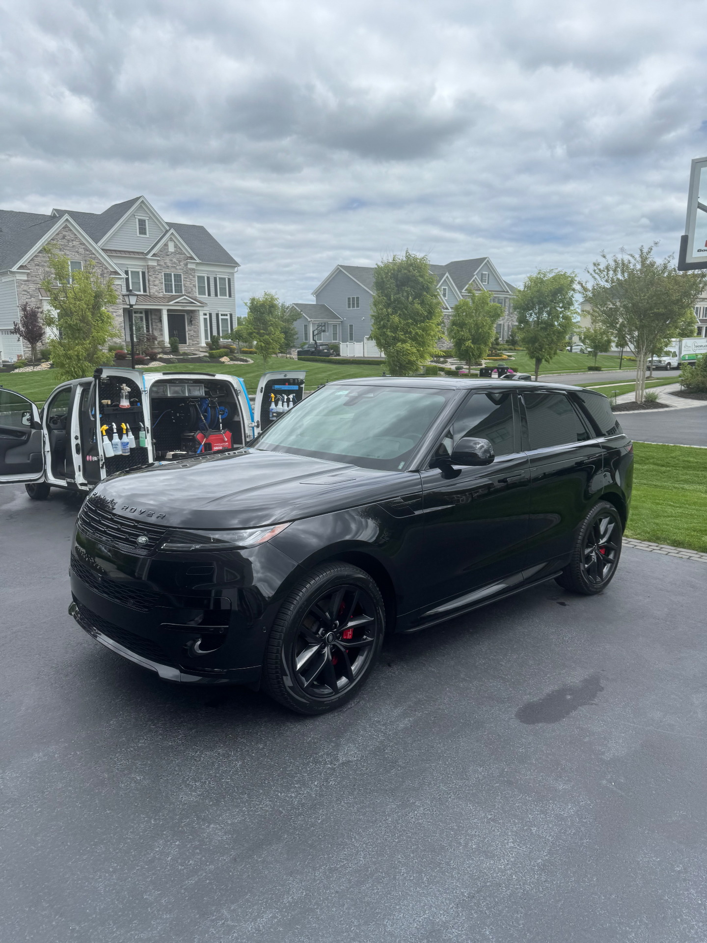 Blacked-out Range Rover Sport mobile detail alongside the Monmouth Detail Co van in Monmouth County, NJ