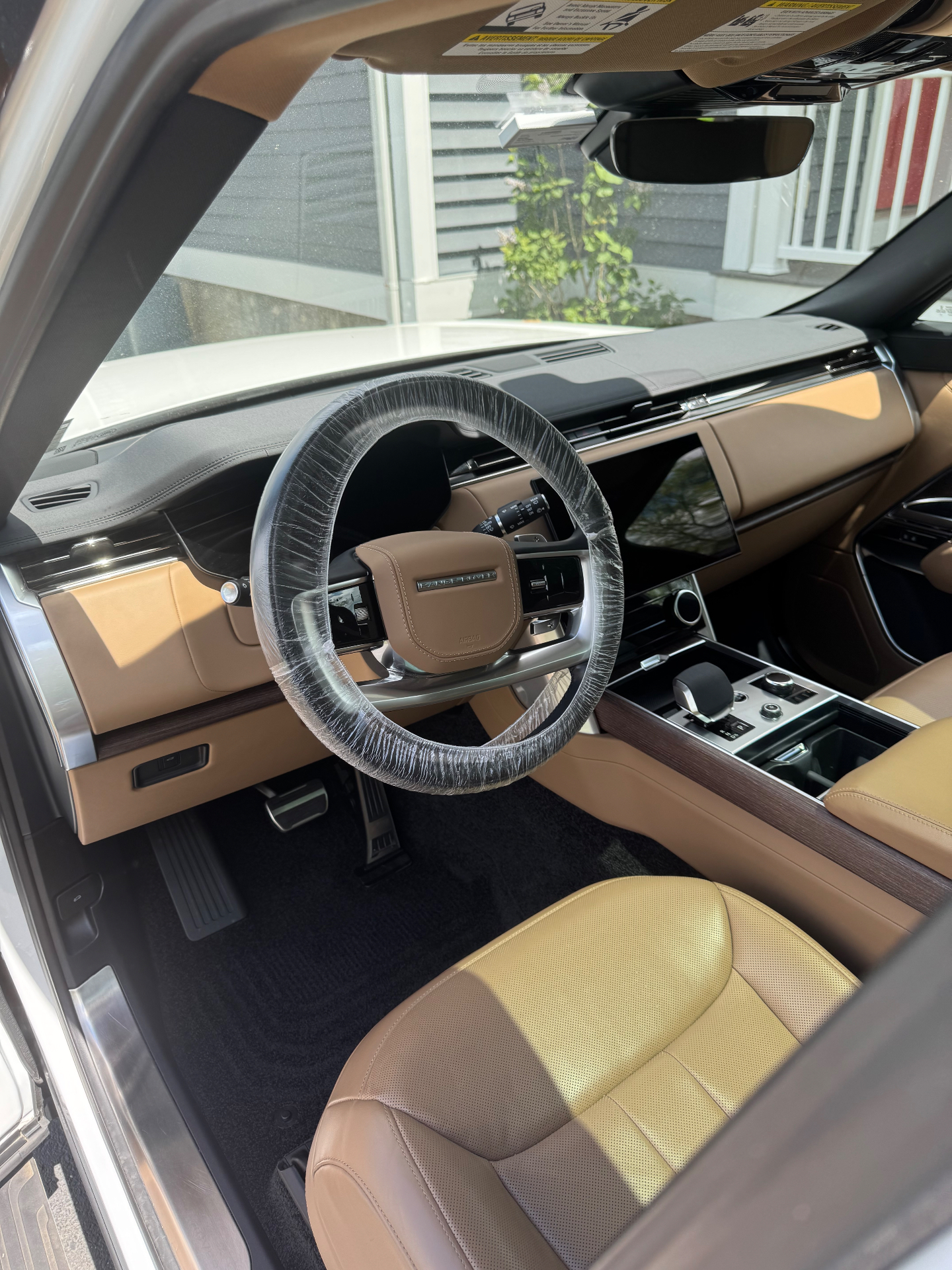 Range Rover tan leather interior detail with protective steering wheel cover by Monmouth Detail Co in Monmouth County, NJ